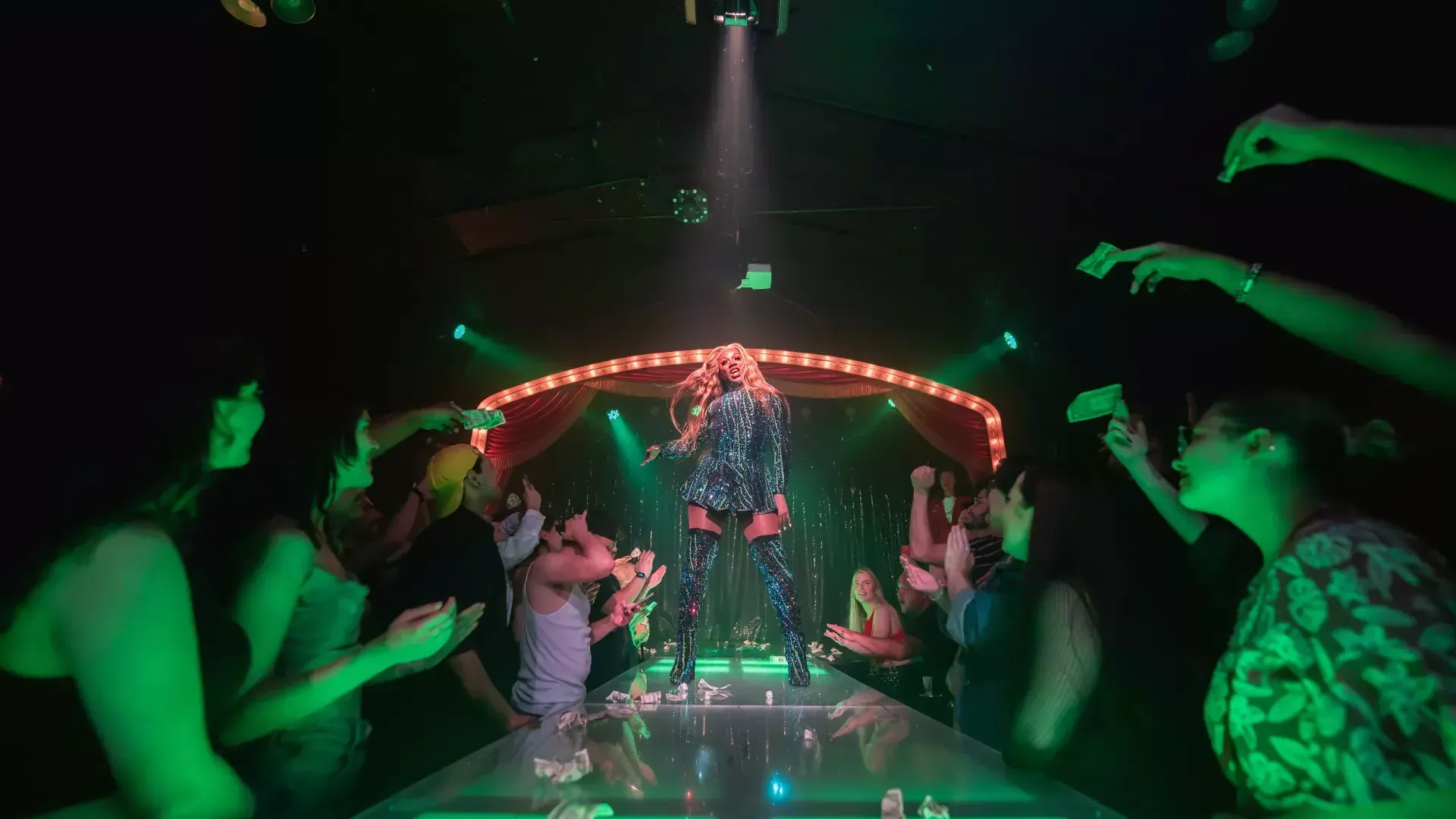 Drag performer dancing for a crowd on the Oasis stage